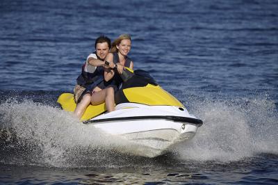 Couple riding jet ski