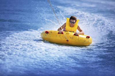 having fun ridding a yellow inflatable tube Miami